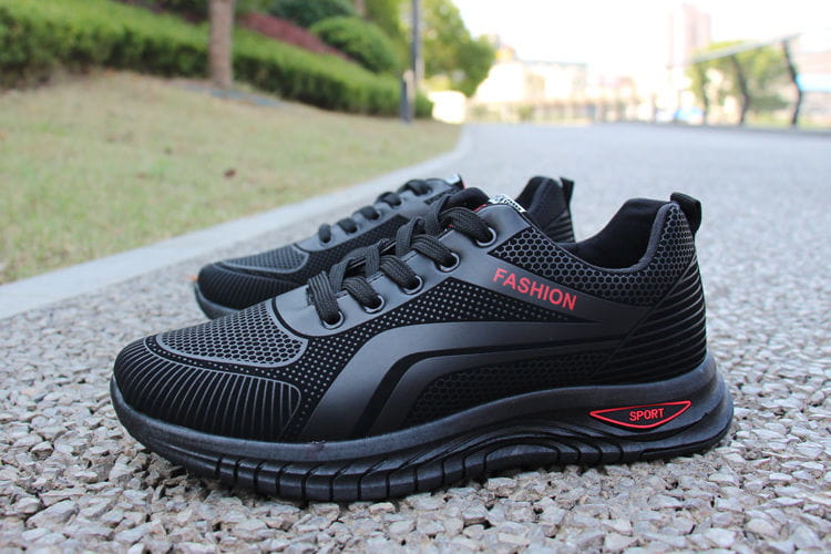 Men breathable athletic sneakers running shoes featuring black mesh and synthetic leather with red fashion and sport branding on the side.