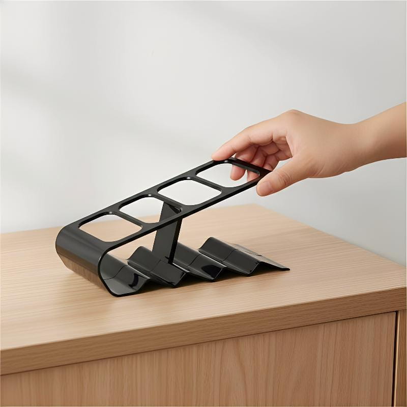 Black plastic remote control organizer desktop storage rack with a sleek modern design and four rectangular slots for wine bottles.