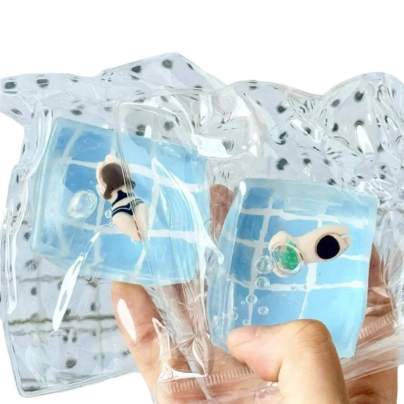 Blue translucent swim ocean maltose squishy cube with cartoon swimmer pattern in clear plastic packaging front view