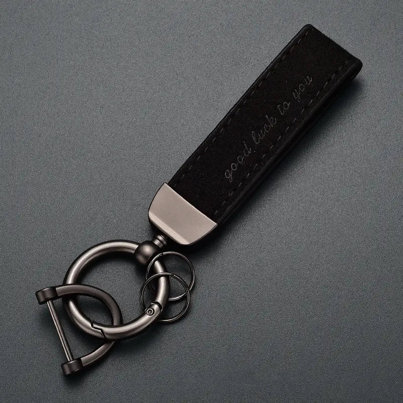 Black leather car keychain with metallic hardware and good luck to you engraved luxury genuine leather key ring.