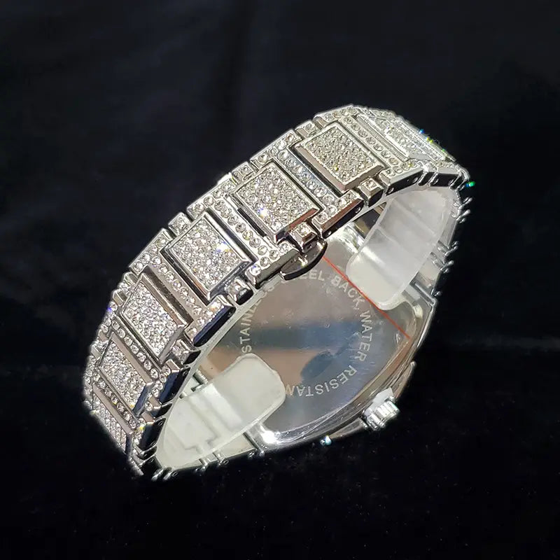 Silver diamond-encrusted watch band with a sleek rectangular link design and polished metal accents for the gold iced out square diamond mens watch luxury quartz.