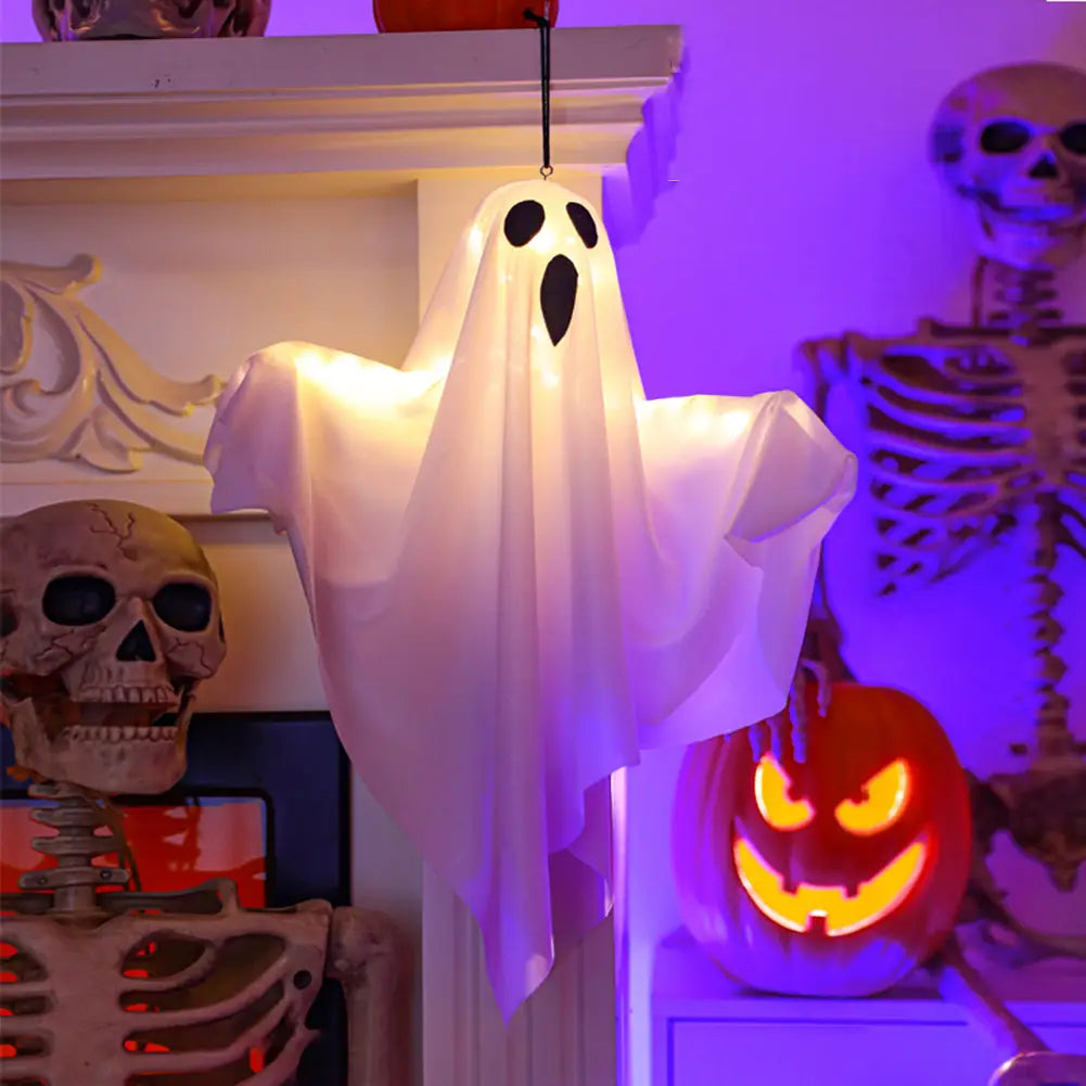 a glowing white inflatable led hanging ghost with black eye and mouth cutouts designed as a halloween decoration hanging from a string
