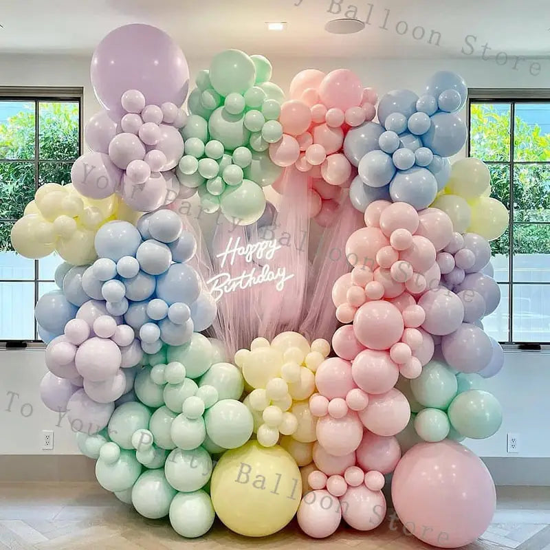 Pastel-colored pink balloon arch kit featuring soft lavender mint green blush pink and pale yellow balloons for wedding and birthday parties.