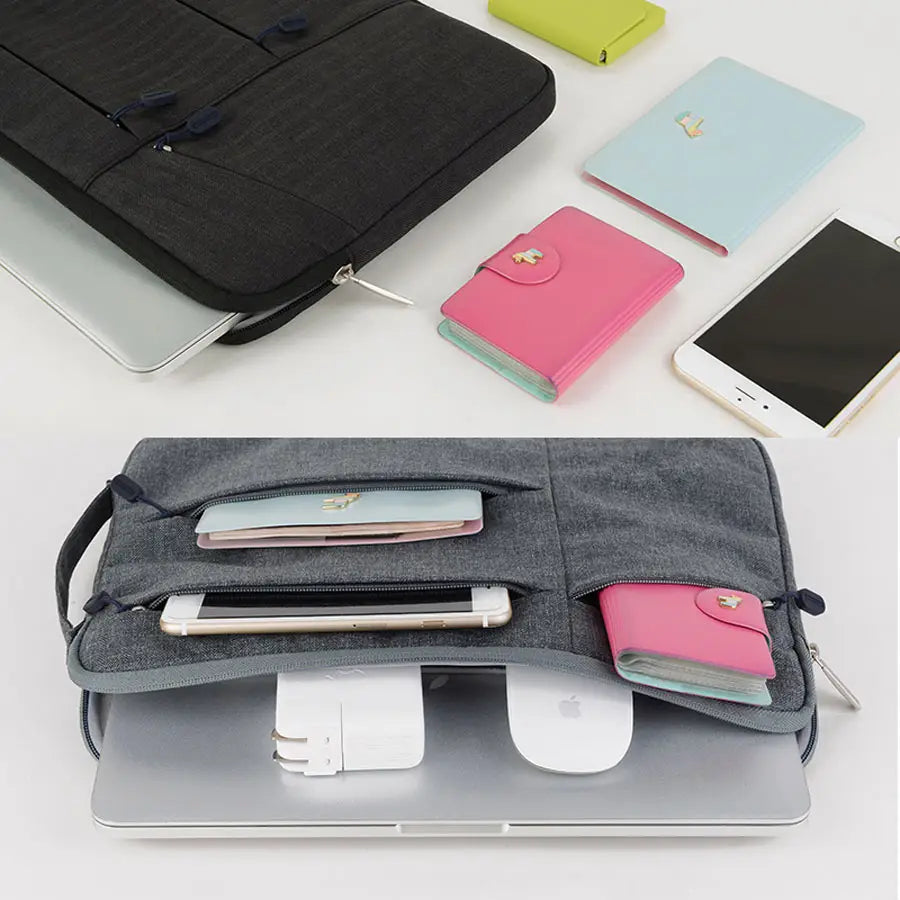 Gray fabric laptop sleeve bag with multiple compartments and a handle designed for MacBook Air and Pro models.