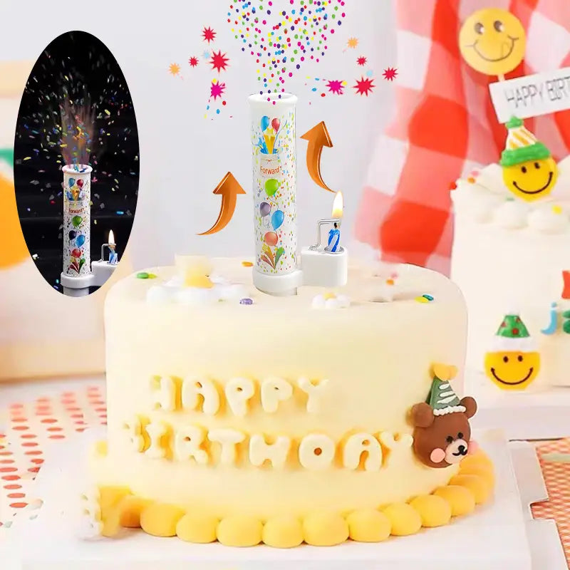White cylindrical birthday cake pop-up confetti candle with colorful balloon design and a lit candle beside it for festive decoration.