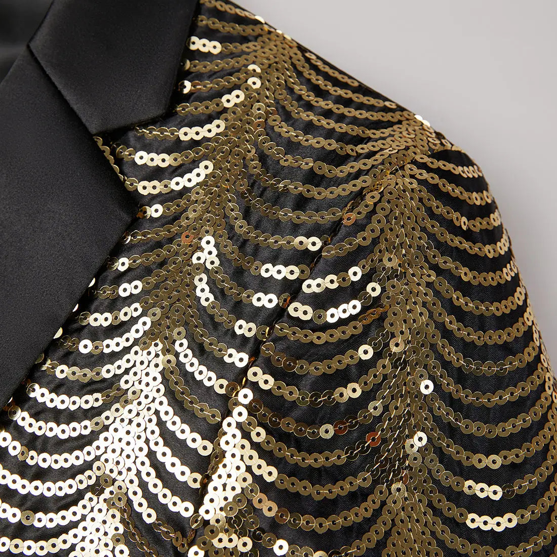 black satin blazer for men featuring gold and white sequins in a cascading wave pattern on the sleeves