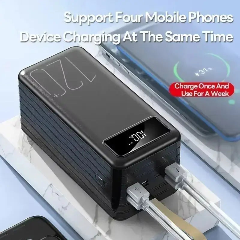 Black rectangular portable power bank with digital display showing 100 percent charge and 720 plus engraved on top surface featuring multiple usb ports for simultaneous device charging.