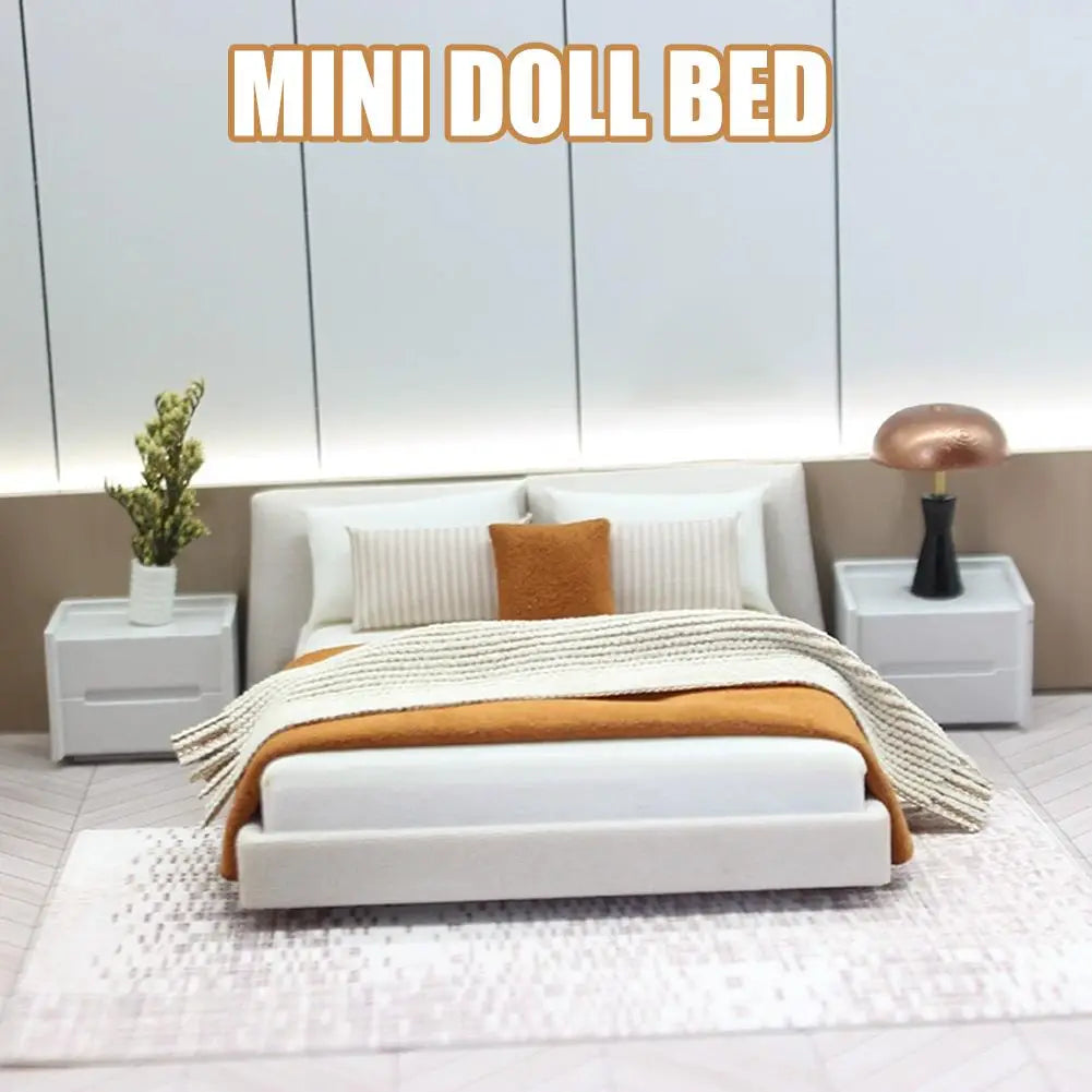 Miniature dollhouse double bed with bedding cream style featuring a white wooden mini doll bed with a sleek modern design and a soft orange throw blanket over the mattress.