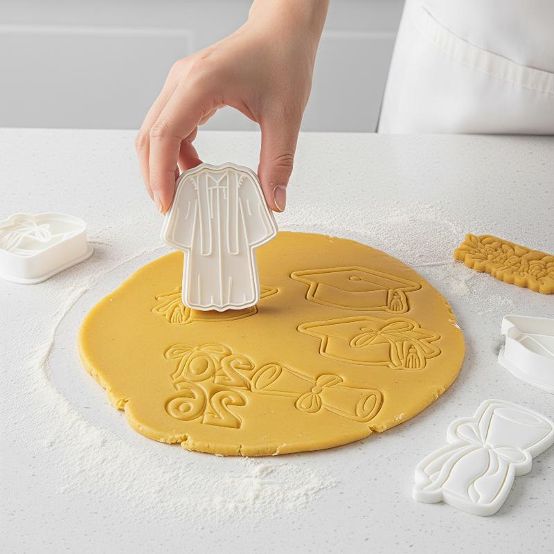 White graduation gown cookie cutter made of durable material featured in the 2026 graduation cookie cutter set for themed baking.