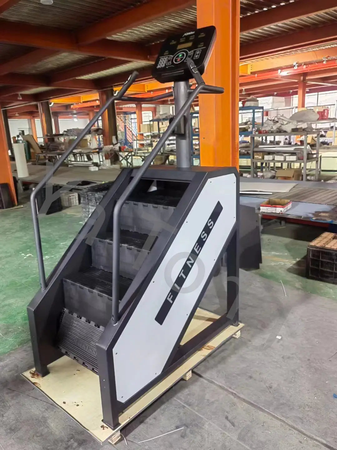 Black and gray commercial stair climber machine with digital display panel designed for cardio stepmill workouts.