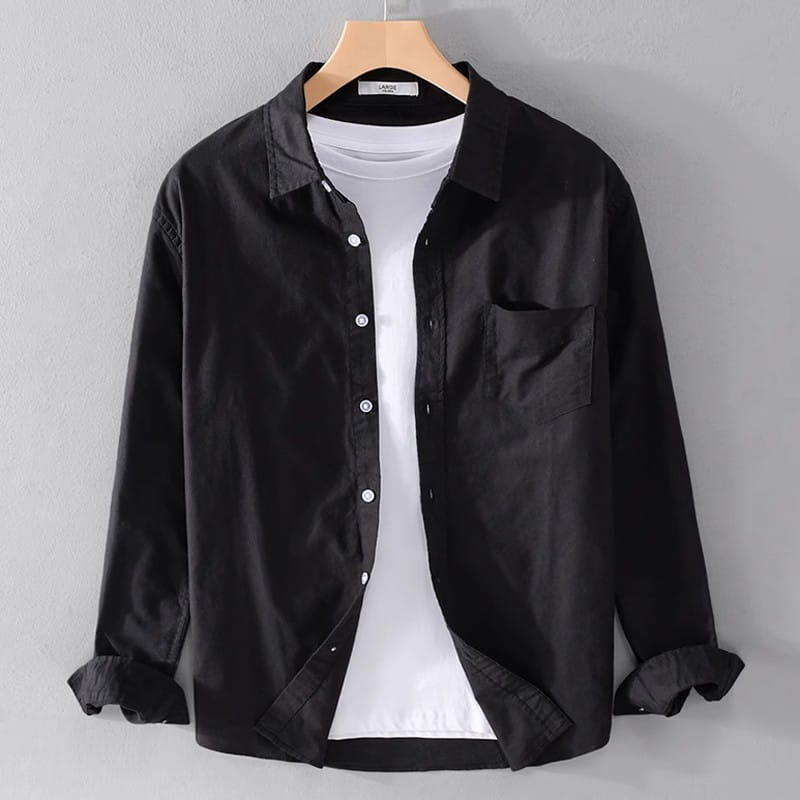 Men’s durable casual long sleeve work shirt in black featuring a chest pocket and rolled cuffs displayed on a wooden hanger.