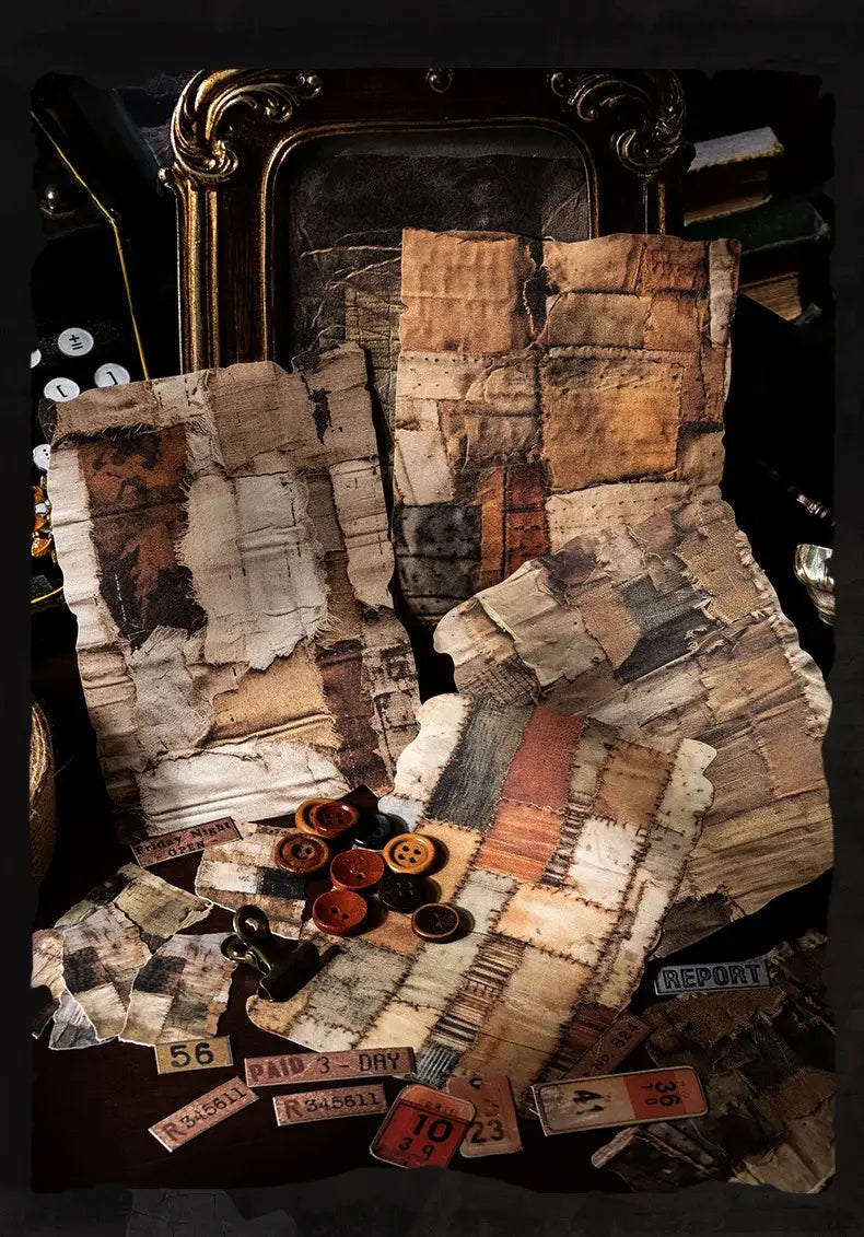 A patchwork textile made of aged distressed fabric pieces in beige brown and faded orange stitched together in a vintage junk journal scrapbook supplies pack.