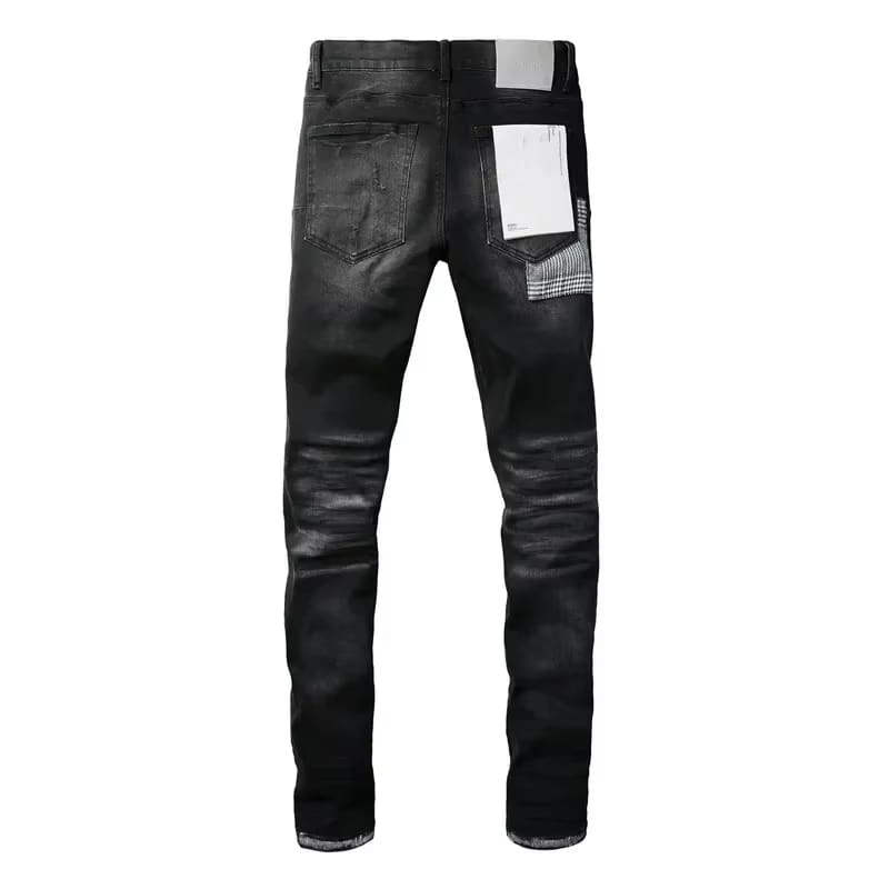 the back side of black distressed patchwork skinny jeans featuring a glossy finish on black denim with contrasting white and black plaid patchwork on the pocket