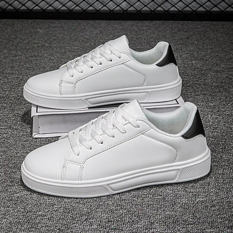 Weiße Ledersneaker im Freizeitstil mit schwarzen Akzenten am Absatz, mit einem klaren minimalistischen Design und leichter Verarbeitung für die sportliche Nutzung.