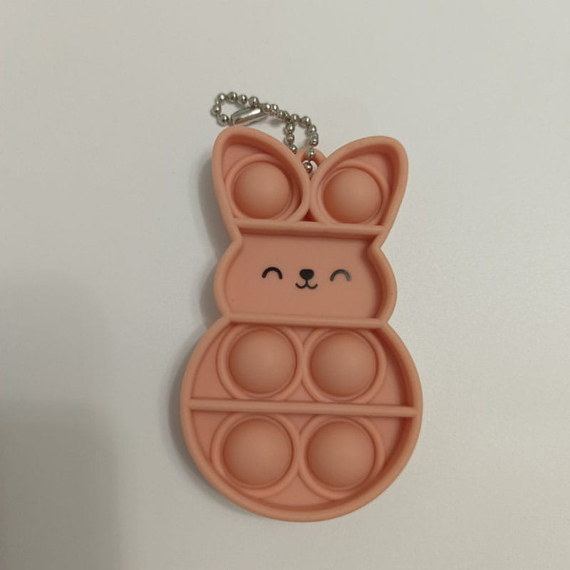 pink silicone bunny-shaped pop it fidget keychain with a silver chain for portable sensory play