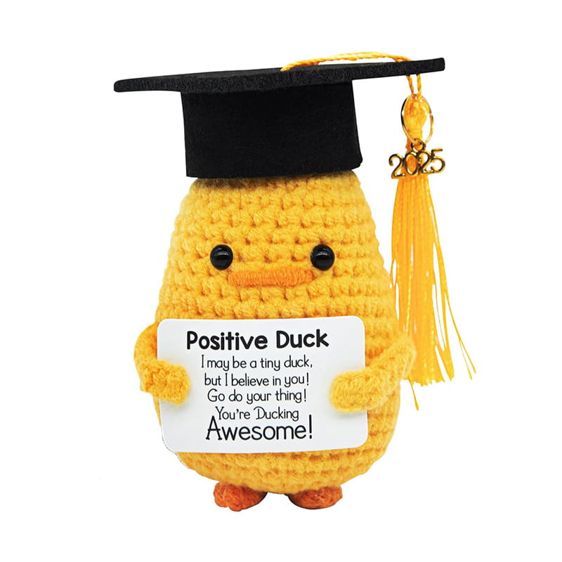 Yellow crocheted graduation duck 2025 gift wearing a black cap with a gold tassel and holding a white sign that reads positive duck.