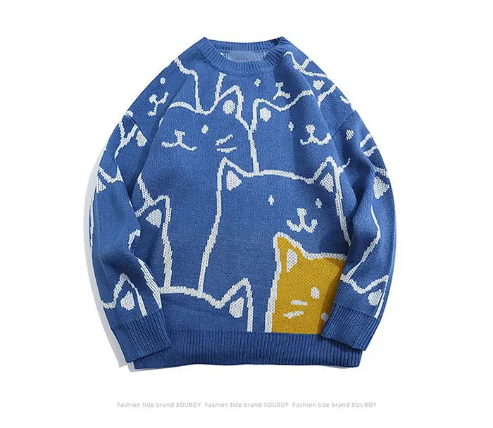 Pull ample en maille bleue, avec un motif ludique de chats de dessin en blanc et jaune, conçu dans un style Harajuku.