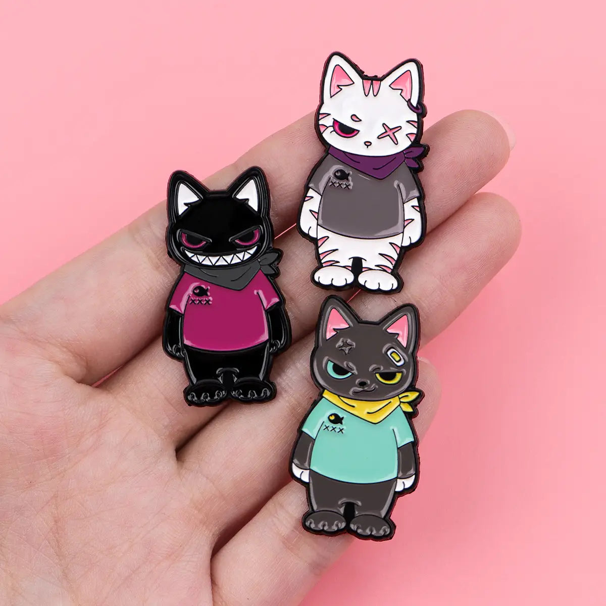 Three stylized cat enamel lapel pins in unique color schemes featuring scarves and bandanas for decorative accessory use.