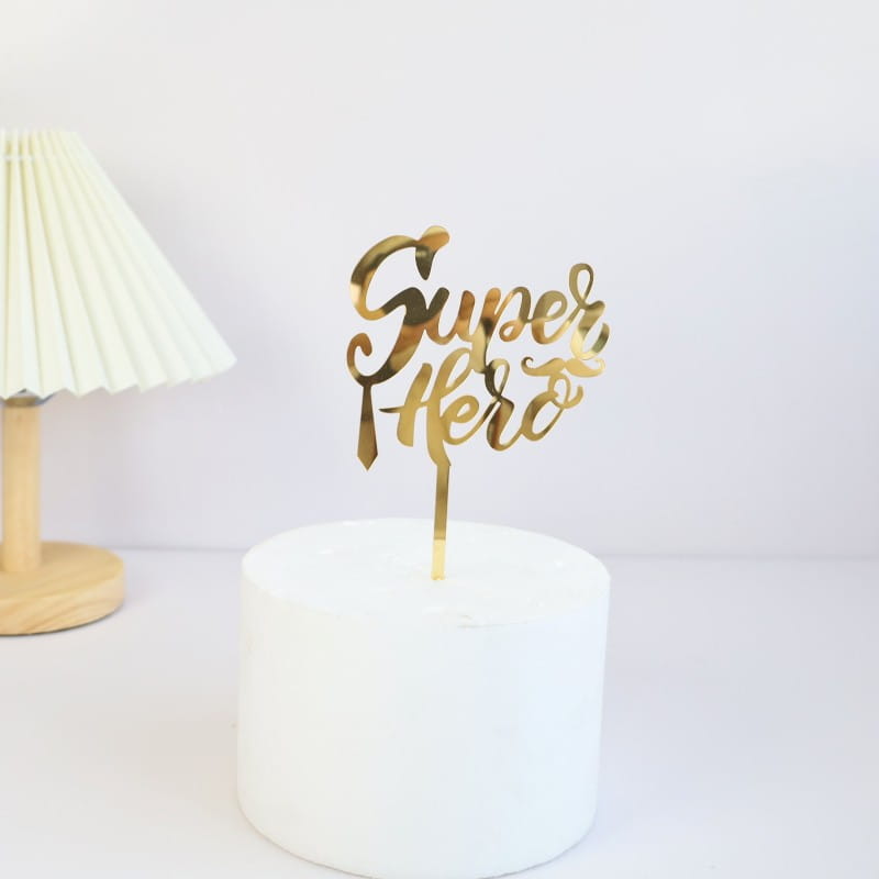 Gold metallic acrylic super hero cake topper with elegant cursive script designed for Father’s Day super dad celebration.