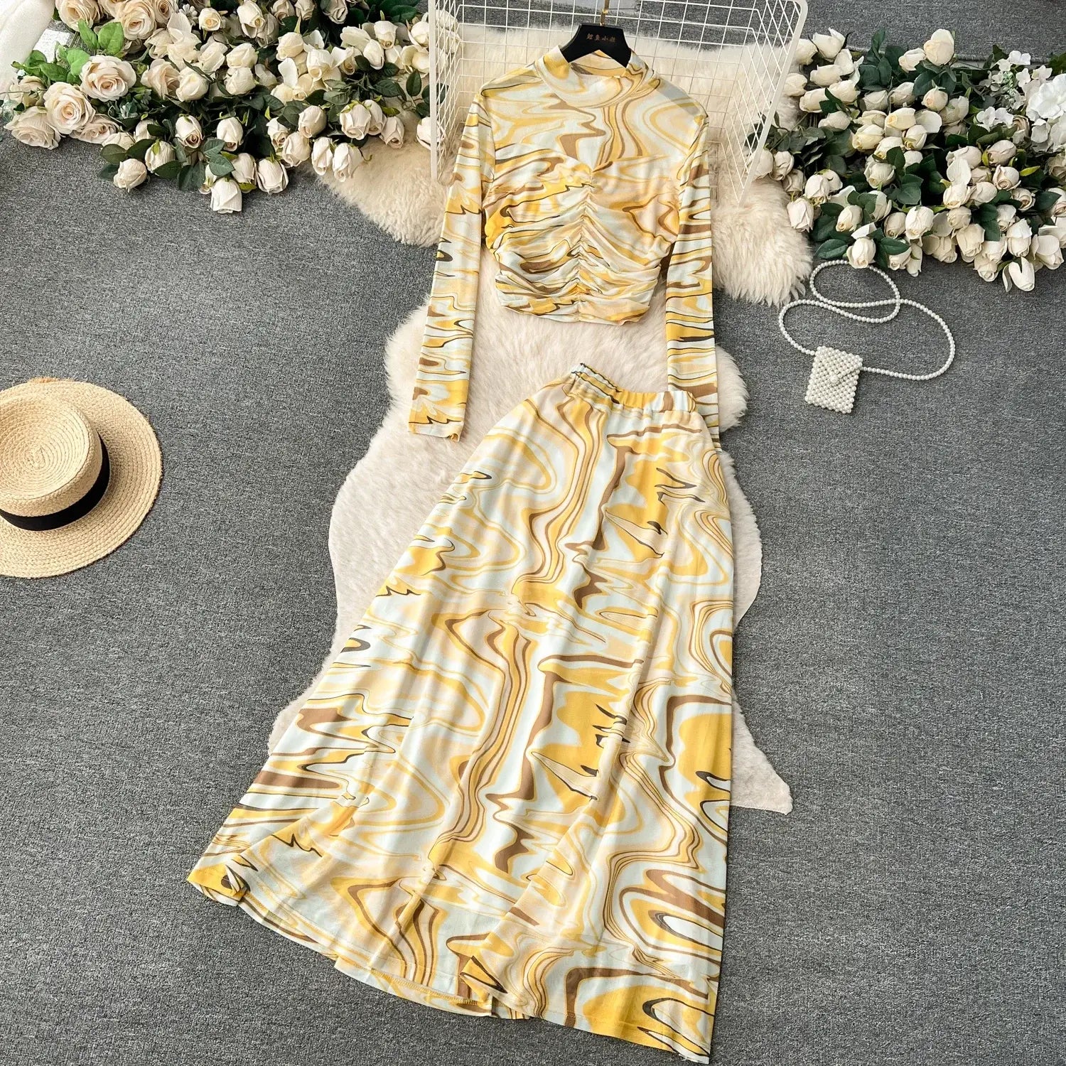 Yellow and white marbled long-sleeve mesh two piece skirt set featuring a ruched bodice and elastic closure.