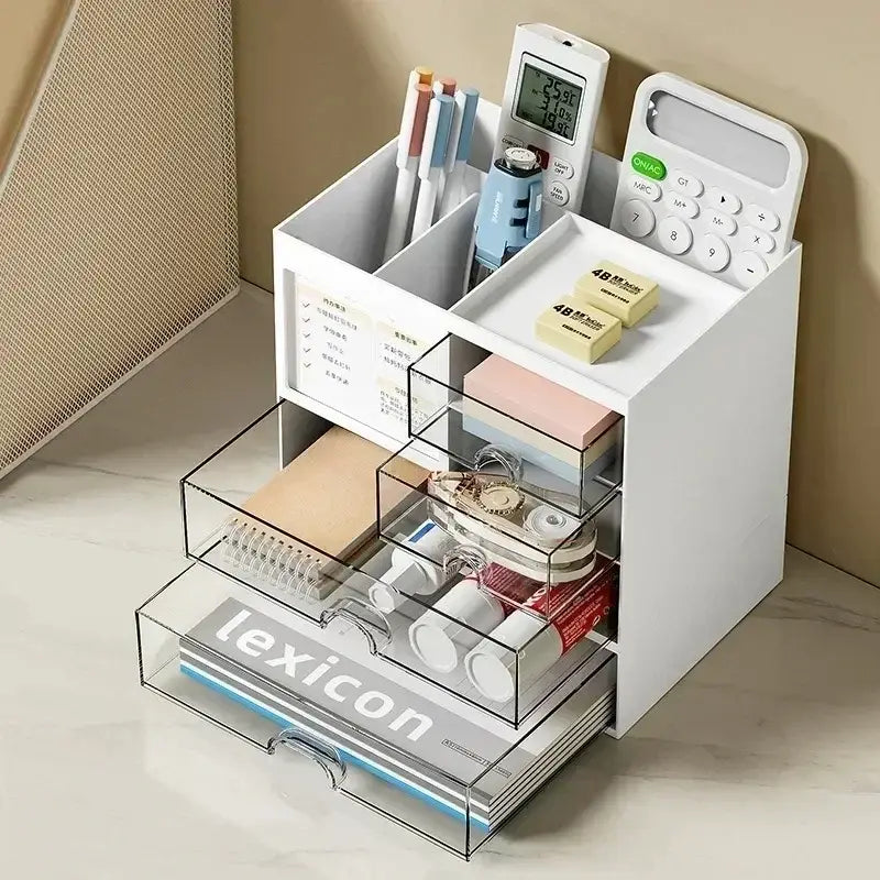 White desk organizer with clear acrylic drawers and compartments holding pens calculator erasers and stationery made of white plastic