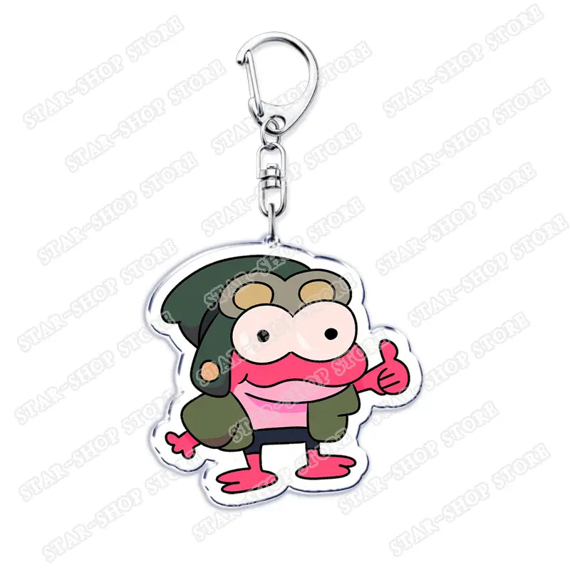 Clear acrylic Amphibia anime keychain featuring a cartoon pink frog character wearing a green military-style hat and jacket giving a thumbs-up gesture.