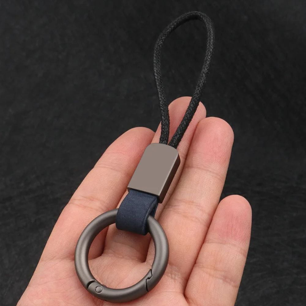 Dark gray metal leather carabiner keychain with navy blue leather strap and black braided cord multifunctional key holder.