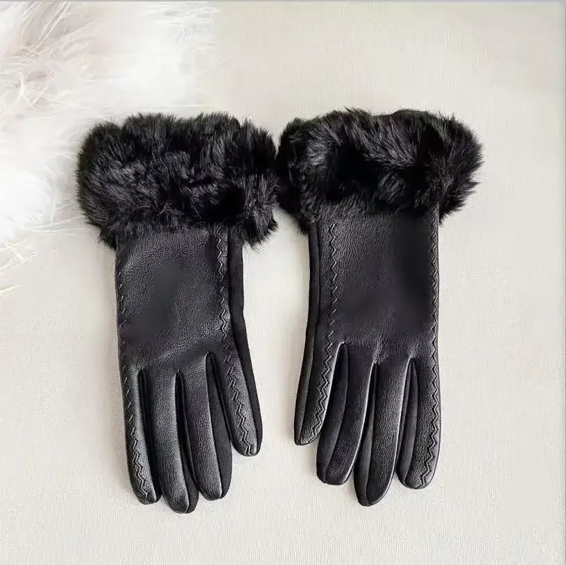 Black leather women’s fur-lined winter gloves featuring plush black fur trim and zigzag stitching along the fingers shown from the back side.
