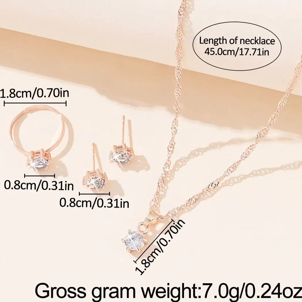 Juego de joyería de 5 piezas con circonitas cúbicas de color dorado rosado, que presenta un collar de cadena trenzada delicada con un dije central de circonita cúbica transparente, aretes a juego tipo botón y un anillo con monturas de piedras similares.