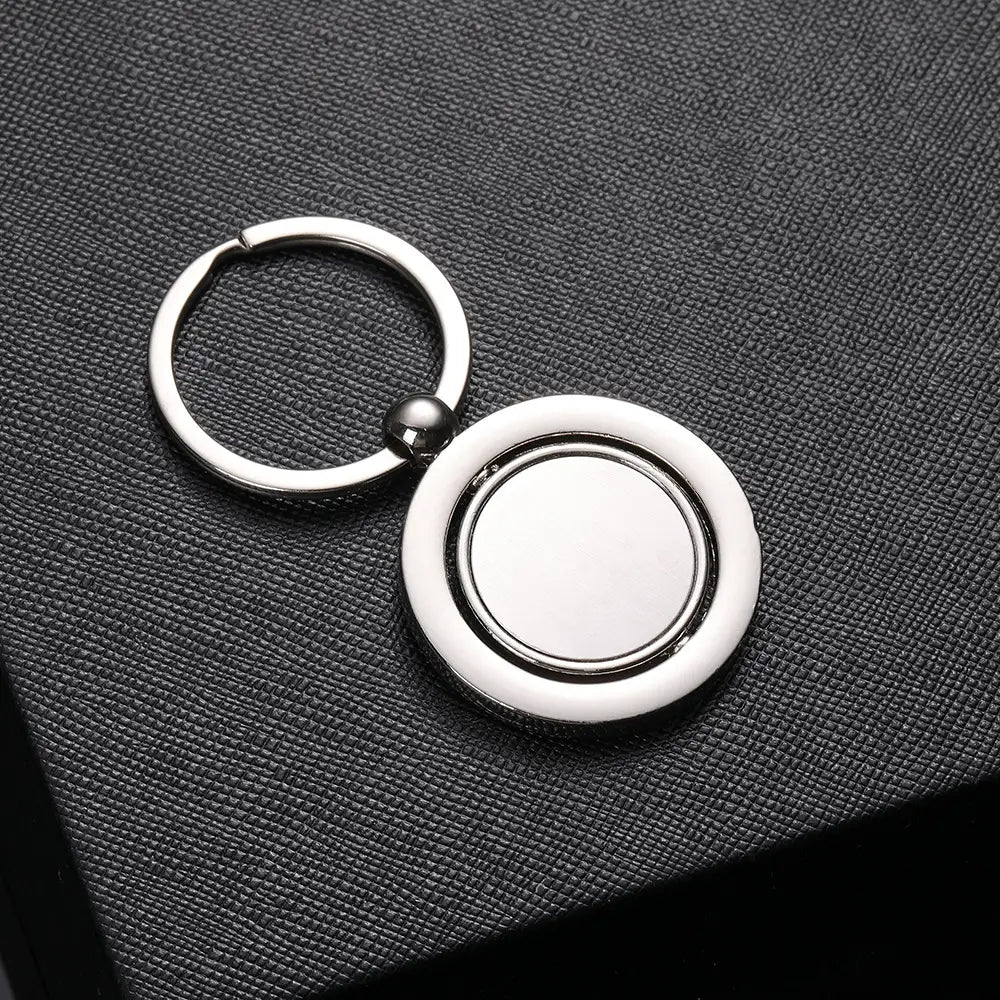 Silver metallic rotating silver circle keychain gift featuring a circular two-tiered design with a smooth central disc and a polished ring.
