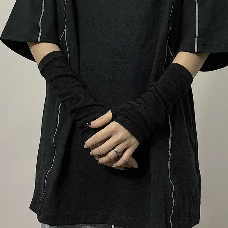 Black striped knit fingerless arm warmers with subtle white piping along the seams and long sleeves.