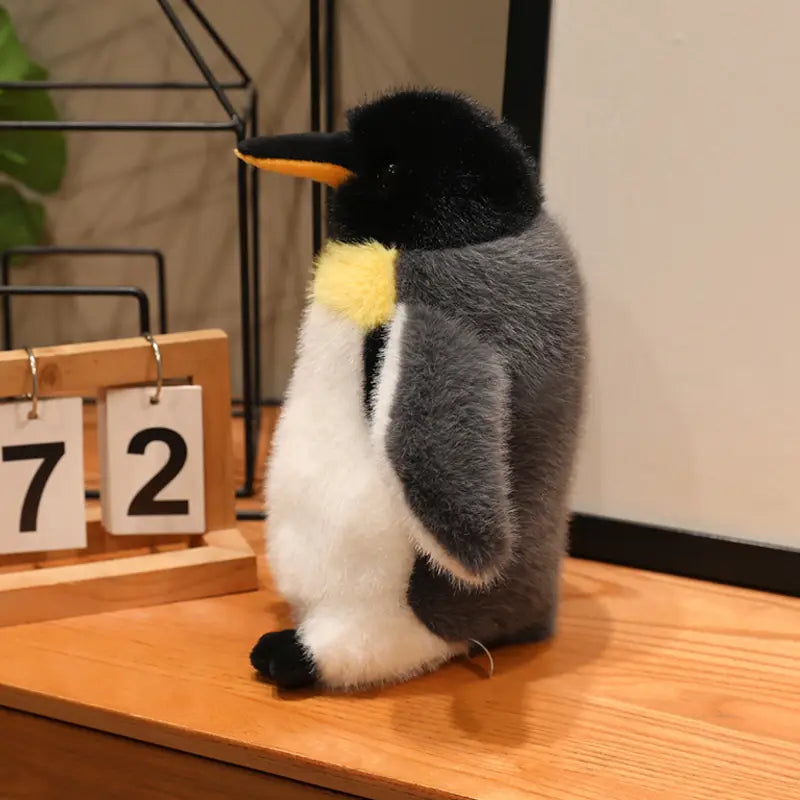 A plush penguin stuffed animal soft toy pair featuring a black head, yellow beak and chest patch, gray back, white belly, and black feet.