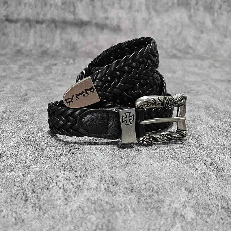 Black braided leather fashion belt male with a silver-toned buckle featuring an ornate rose design and cross emblem for luxury designer punk style.