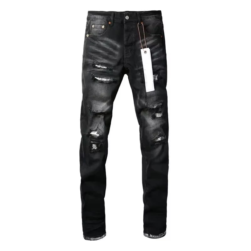 Black distressed patchwork skinny jeans in black denim featuring multiple ripped patches and frayed hems.
