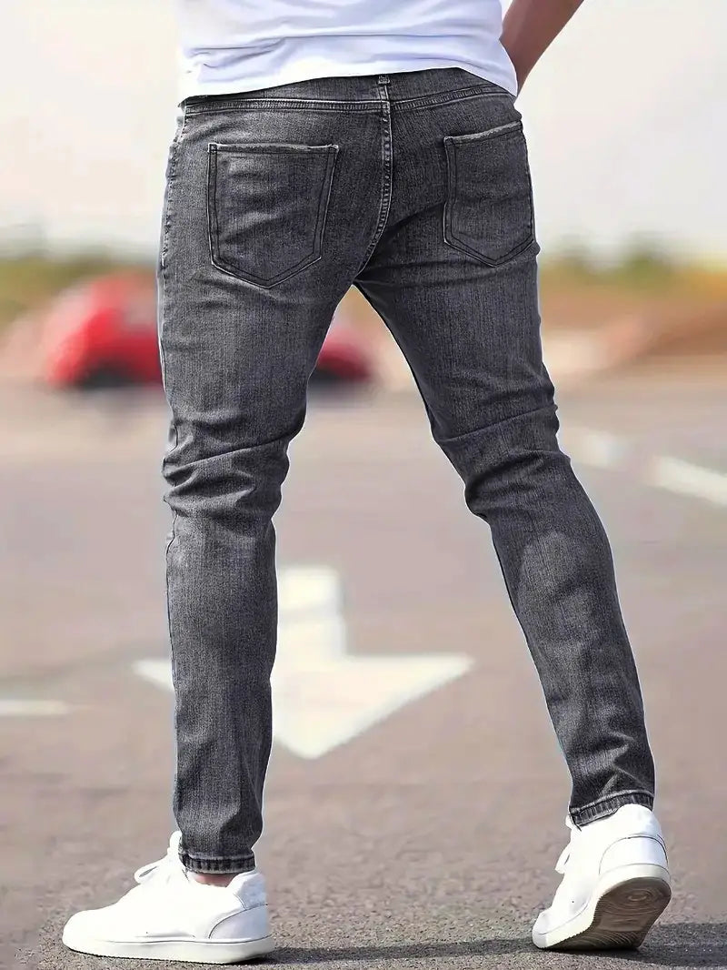Dark gray slim-fit denim men’s distressed skinny jeans featuring a classic five-pocket design and vintage style.