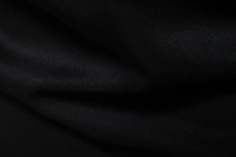 Black fabric with a soft, slightly textured surface and gentle folds of the men asymmetrical slant collar long sleeve casual shirt.