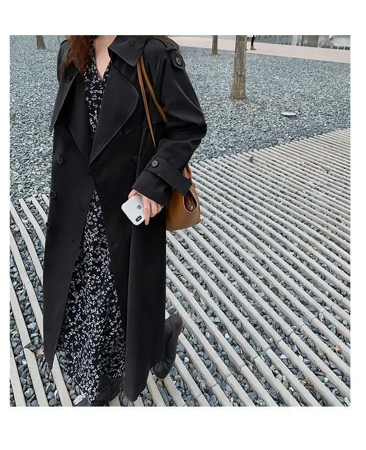 Black double-breasted trench coat with epaulets designed as a casual windbreaker for women.