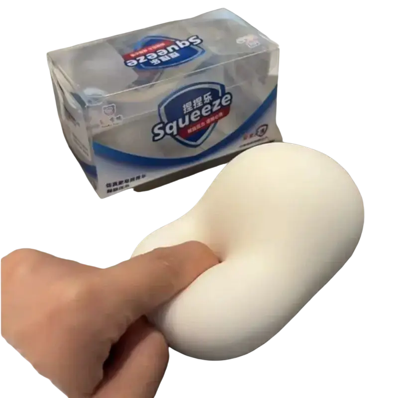 White soft silicone soap squishy toy being squeezed for stress relief and sensory hand decompression