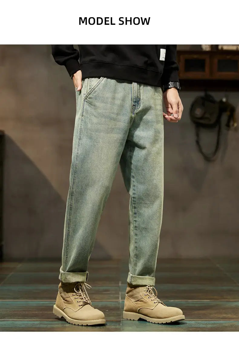 Men loose denim harem jeans in light-wash denim with a relaxed straight-leg cut and rolled cuffs.