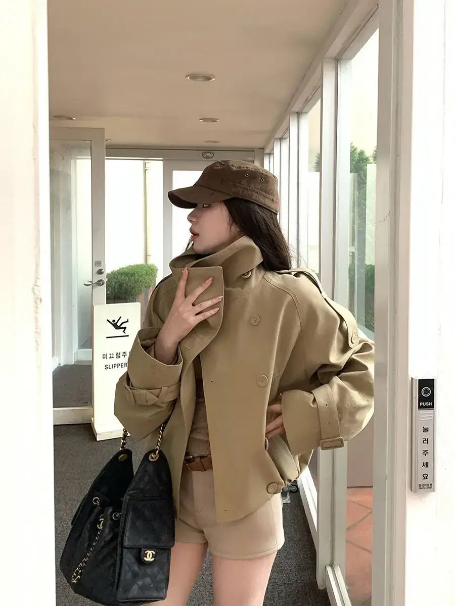 A tan Korean style trench coat beige utility jacket with a structured collar and double-breasted front made from durable material.