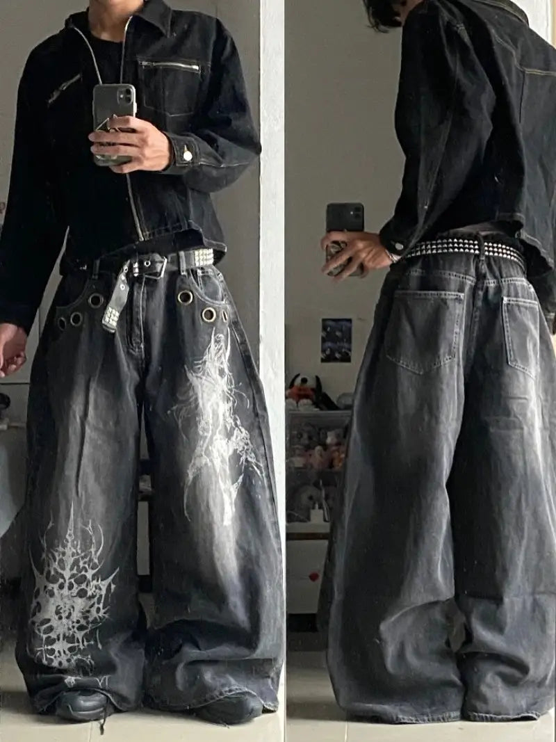 Black distressed denim Y2k Gothic graphic wide leg jeans for men featuring white skull and gothic design graphics.