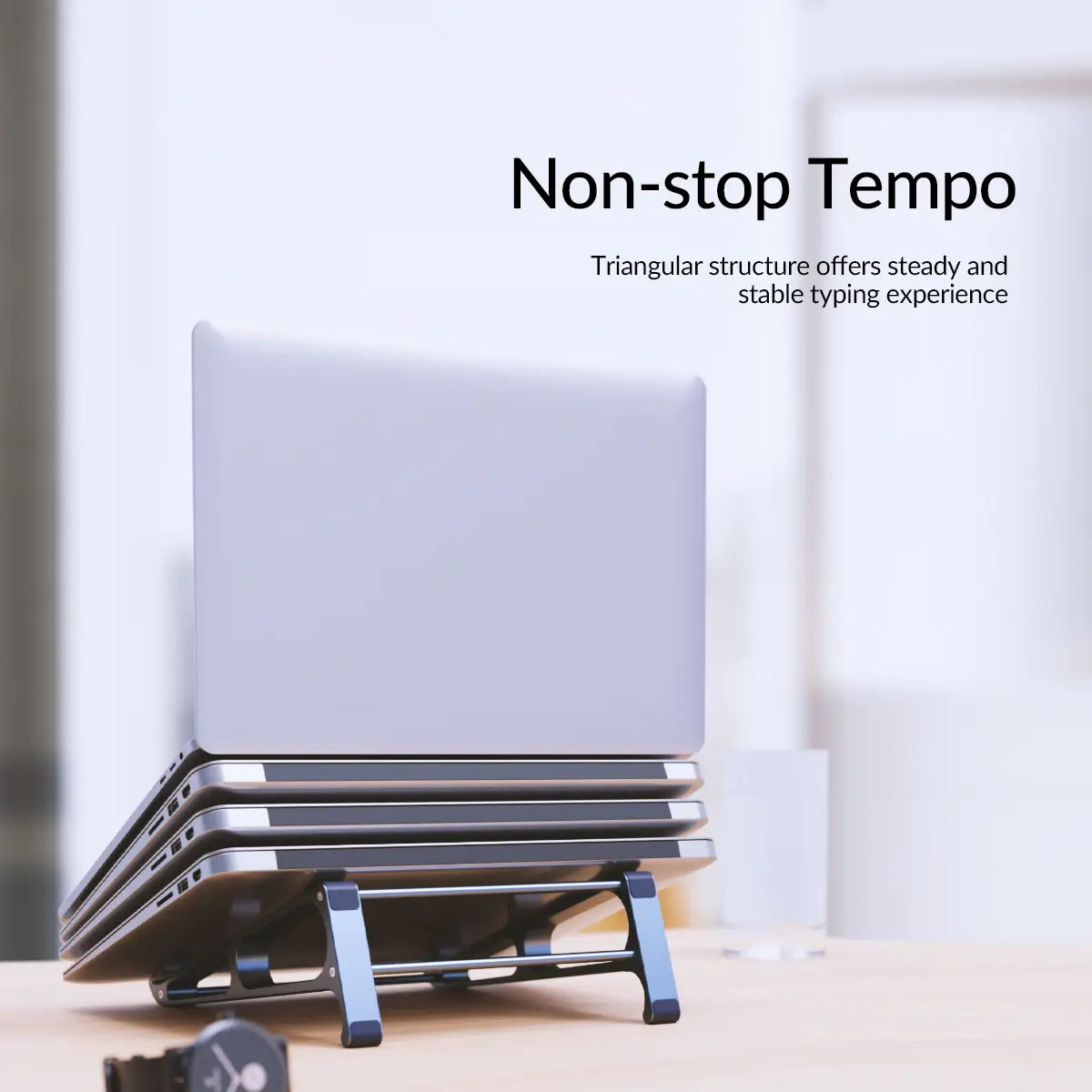 silver orico portable aluminum laptop stand with a triangular structure designed to support multiple laptops as a desktop riser