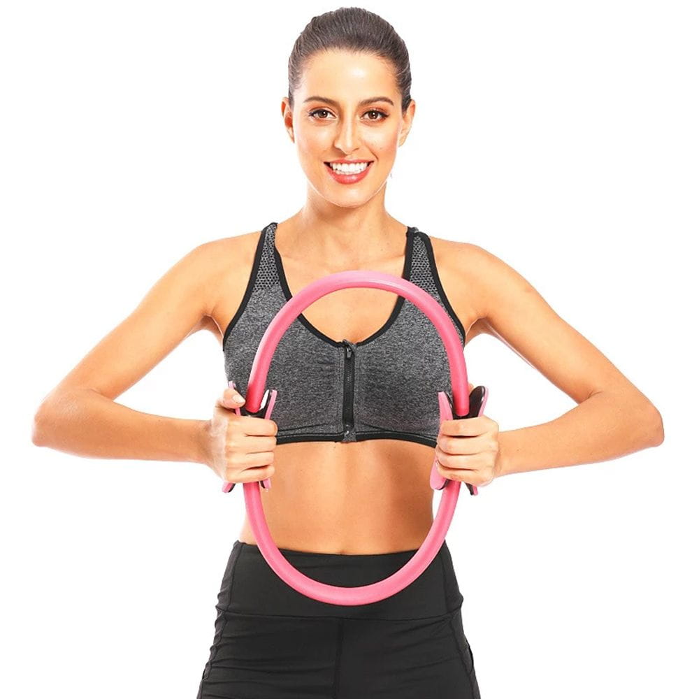 pink pilates ring with padded handles made of durable material designed for fitness magic circle yoga equipment use.