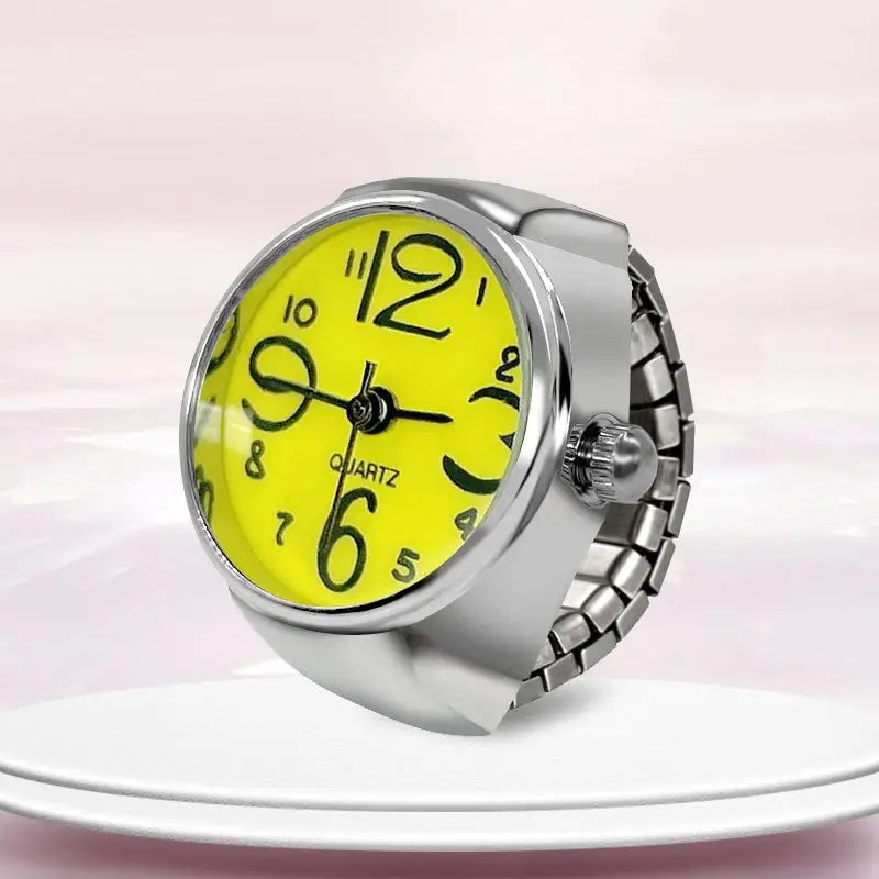A bright yellow quartz ring watch with bold black numerals and a silver-toned adjustable metal band designed as finger couple jewelry.