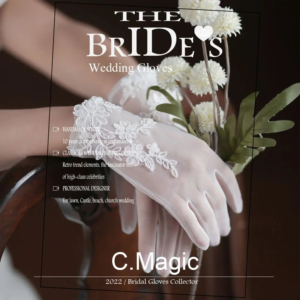 White lace bridal gloves with short tulle applique featuring delicate floral embroidery and sheer mesh texture designed for classic wedding occasions.