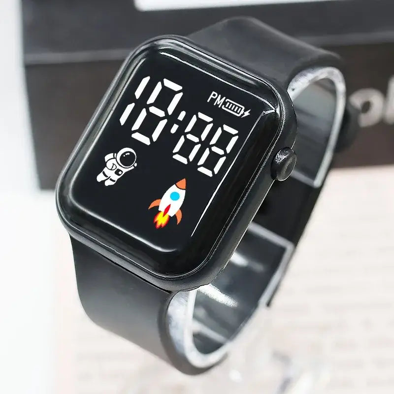 Montre électronique noire pour enfants, garçons et filles, avec affichage numérique sportif LED carré et un design d’astronaute et de fusée.