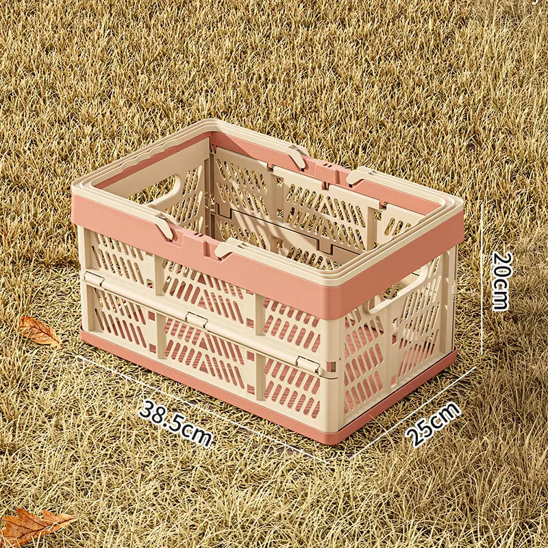 A pink and cream foldable plastic storage basket with a lattice design and collapsible feature for versatile use.