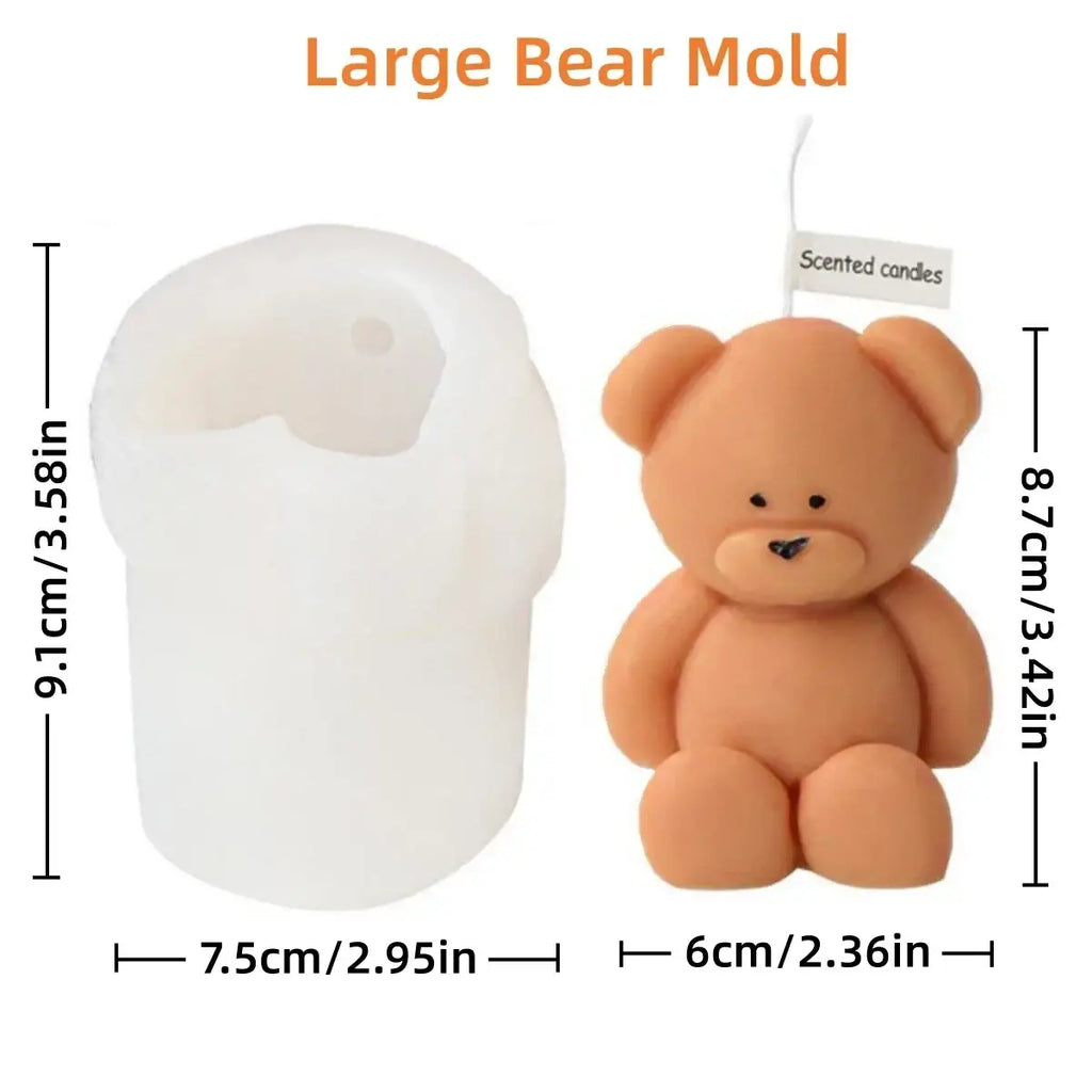 A soft peach-colored mini teddy bear bear candle with black embroidered eyes and nose shown from the front