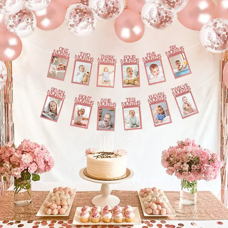 Rose gold photo banner made of metallic foil featuring baby milestone photos and text labels for a 1st birthday monthly picture garland.