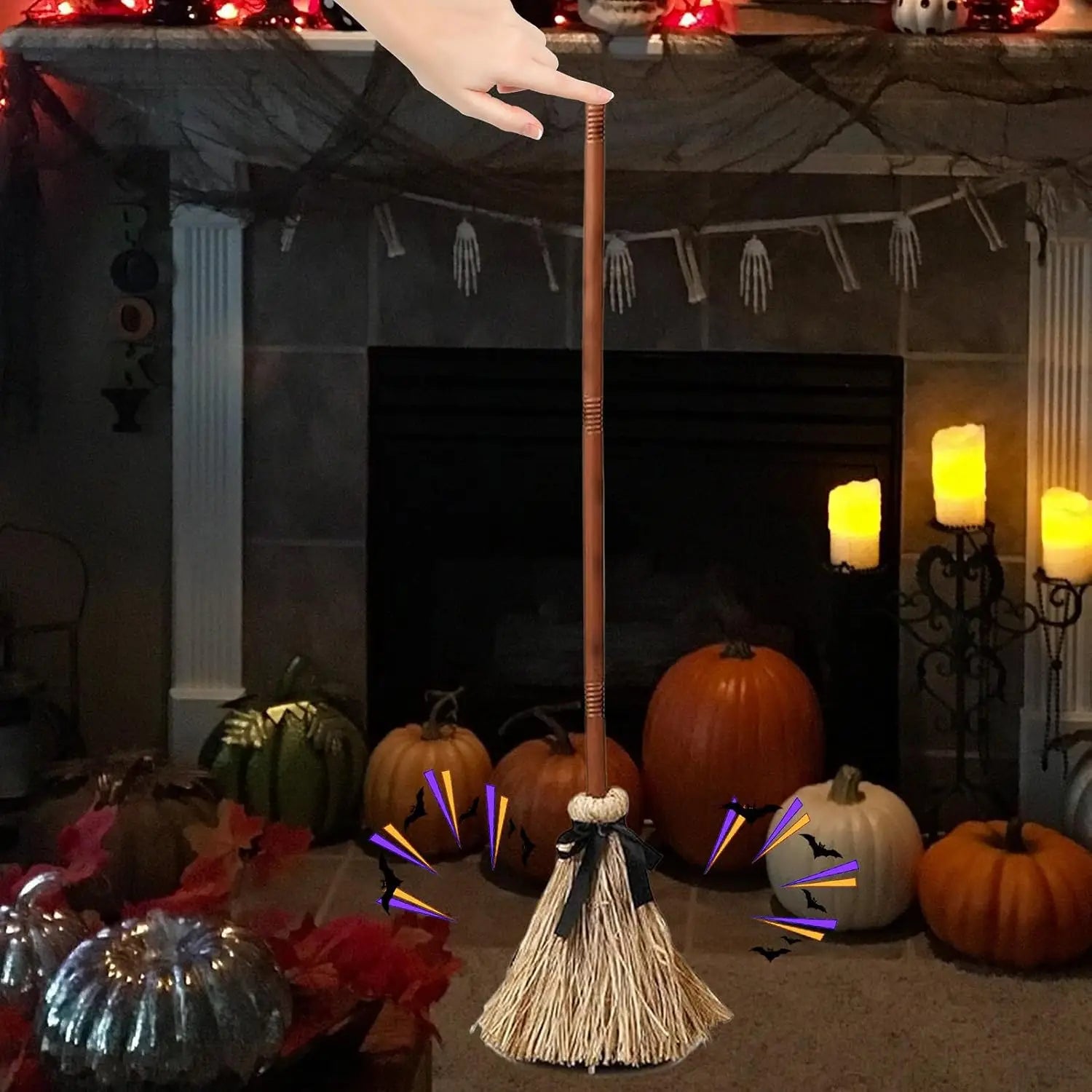 An animated floating witch broom Halloween prop with a rustic wooden handle natural straw bristle head and black ribbon tied around the base.